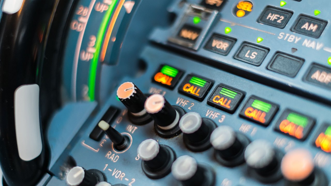 The audio control panel on the pedestal, its CALL lights lit
